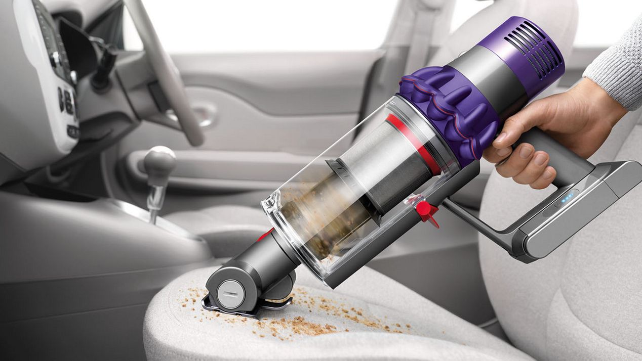  Dyson Cyclone V10™ vacuum in handheld mode cleaning car seat