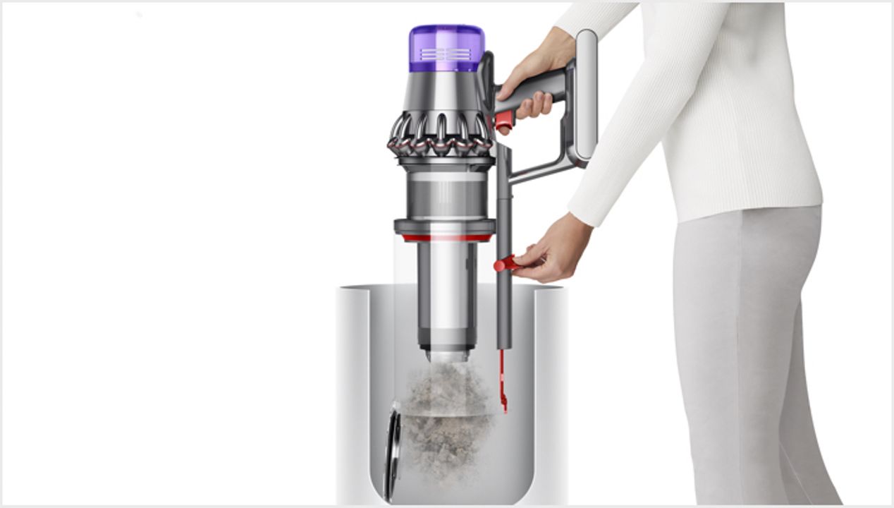 Woman emptying Dyson Outsize vacuum into bin Woman emptying Dyson Outsize vacuum into bin