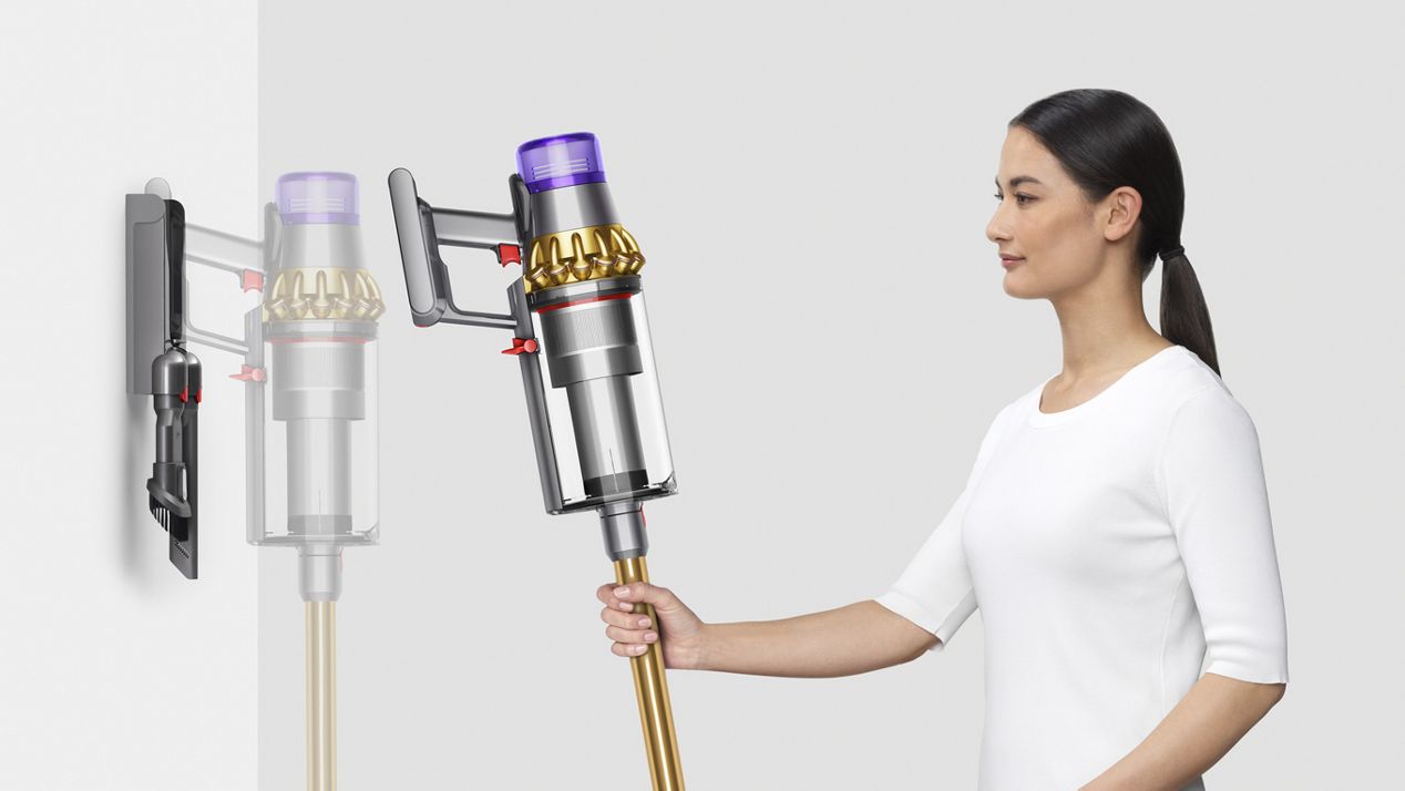 Dyson Outsize vacuum being placed into wall charging dock