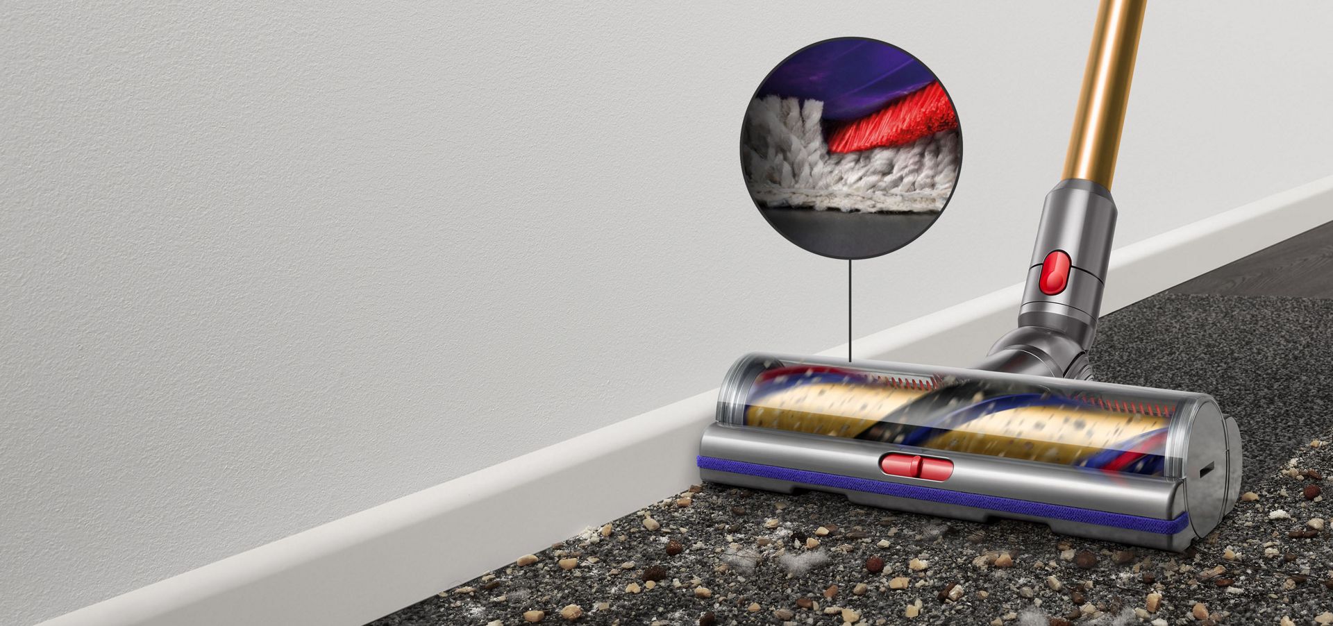 Digital Motorbar cleaner head leaves behind it a clean streak along a beige carpet littered in dirt and debris.