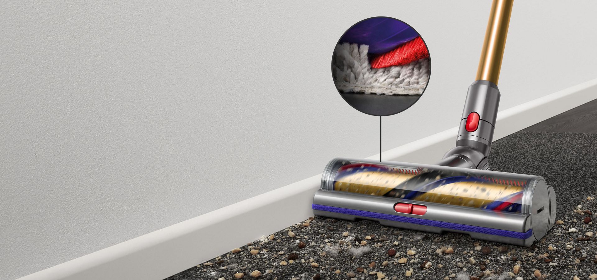 Digital Motorbar cleaner head leaves behind it a clean streak along a beige carpet littered in dirt and debris.