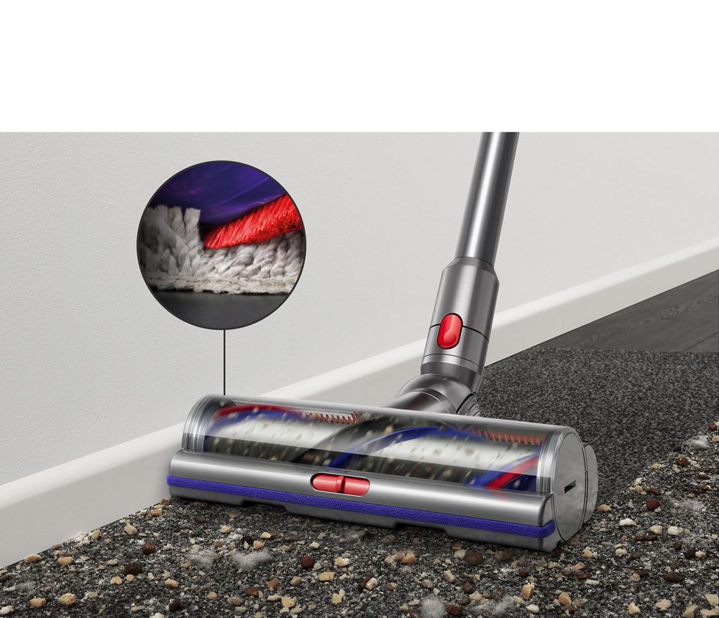 Digital Motorbar cleaner head leaves behind it a clean streak along a beige carpet littered in dirt and debris.