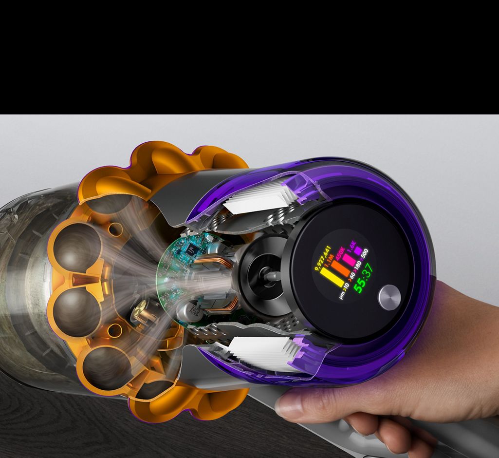 A cutaway of the side of a Dyson V15s showing debris being filtered with the LCD user screen displaying the run time and particle counts.