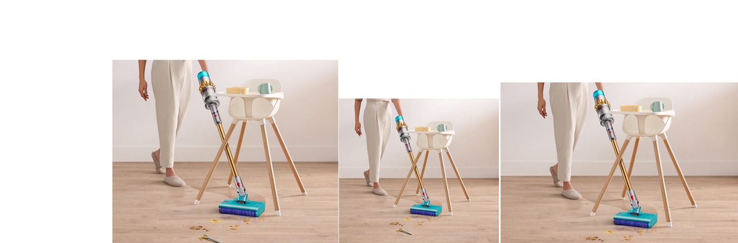 Dyson V15s Detect Submarine Absolute wet roller head angled in between a high chairs legs. Dyson V15s Detect Submarine wet roller head angled in between a high chairs legs clearing spilt food and drink off a laminate floor.