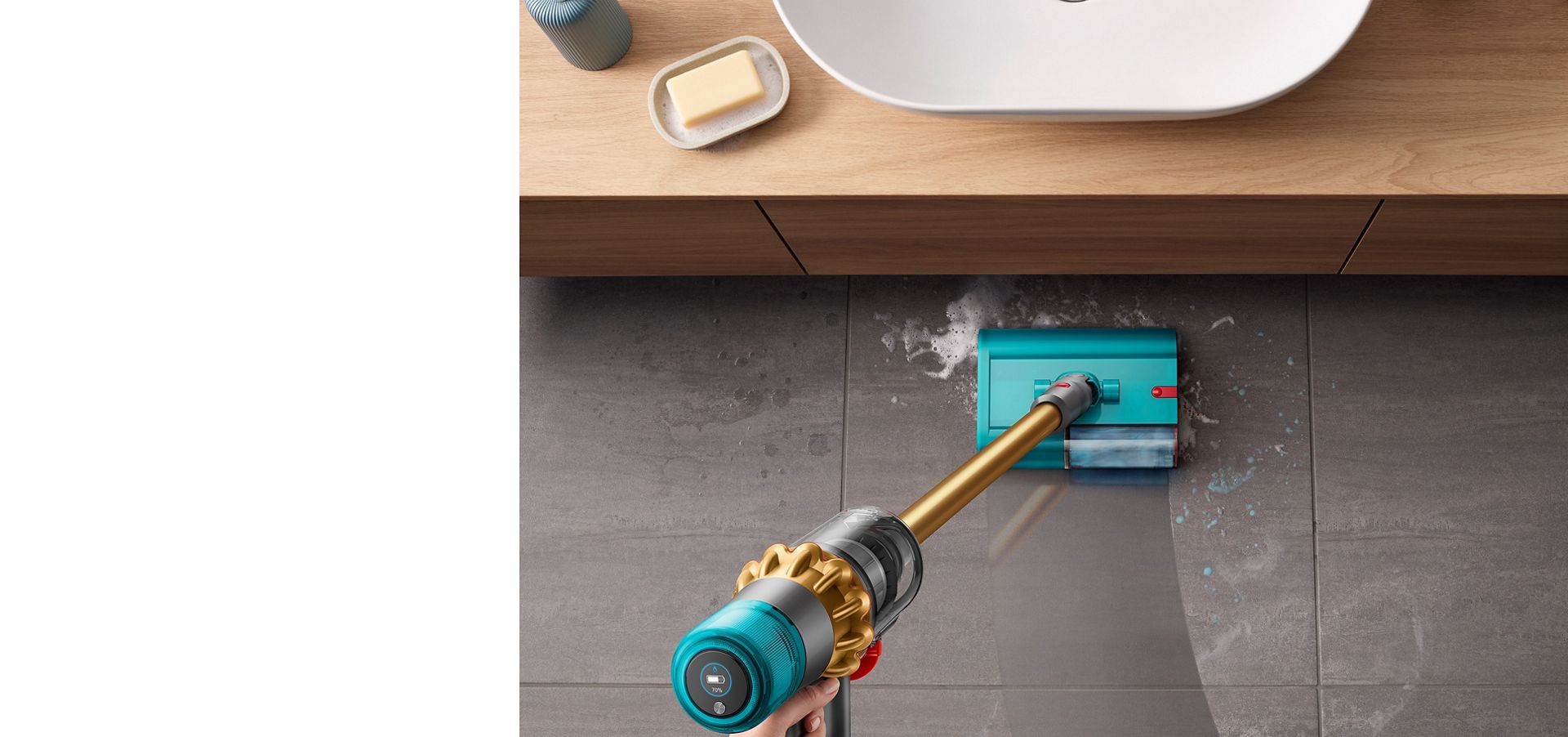 Dyson V15s Detect Submarine wet roller head cleaning a tiled bathroom floor from soapy water and toothpaste with a basin located to the front.