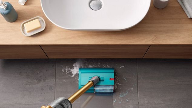 Dyson V15s Detect Submarine wet roller head cleaning a tiled bathroom floor.