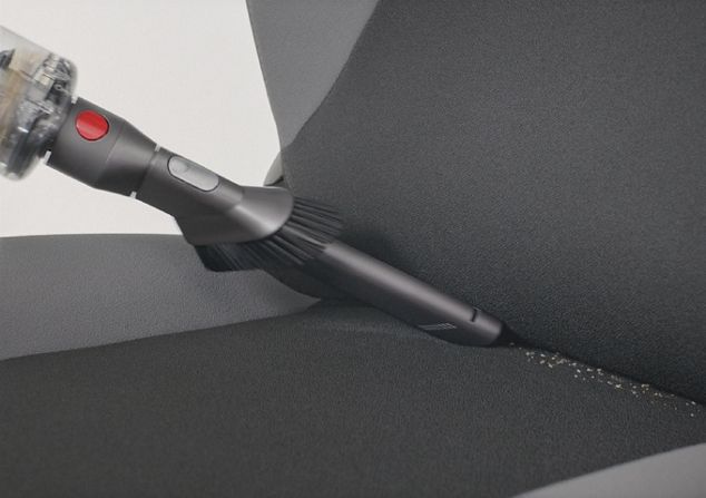 Dyson Omni-glide™ Staubsauger bei der Reinigung eines Autositzes im Handstaubsaugermodus.