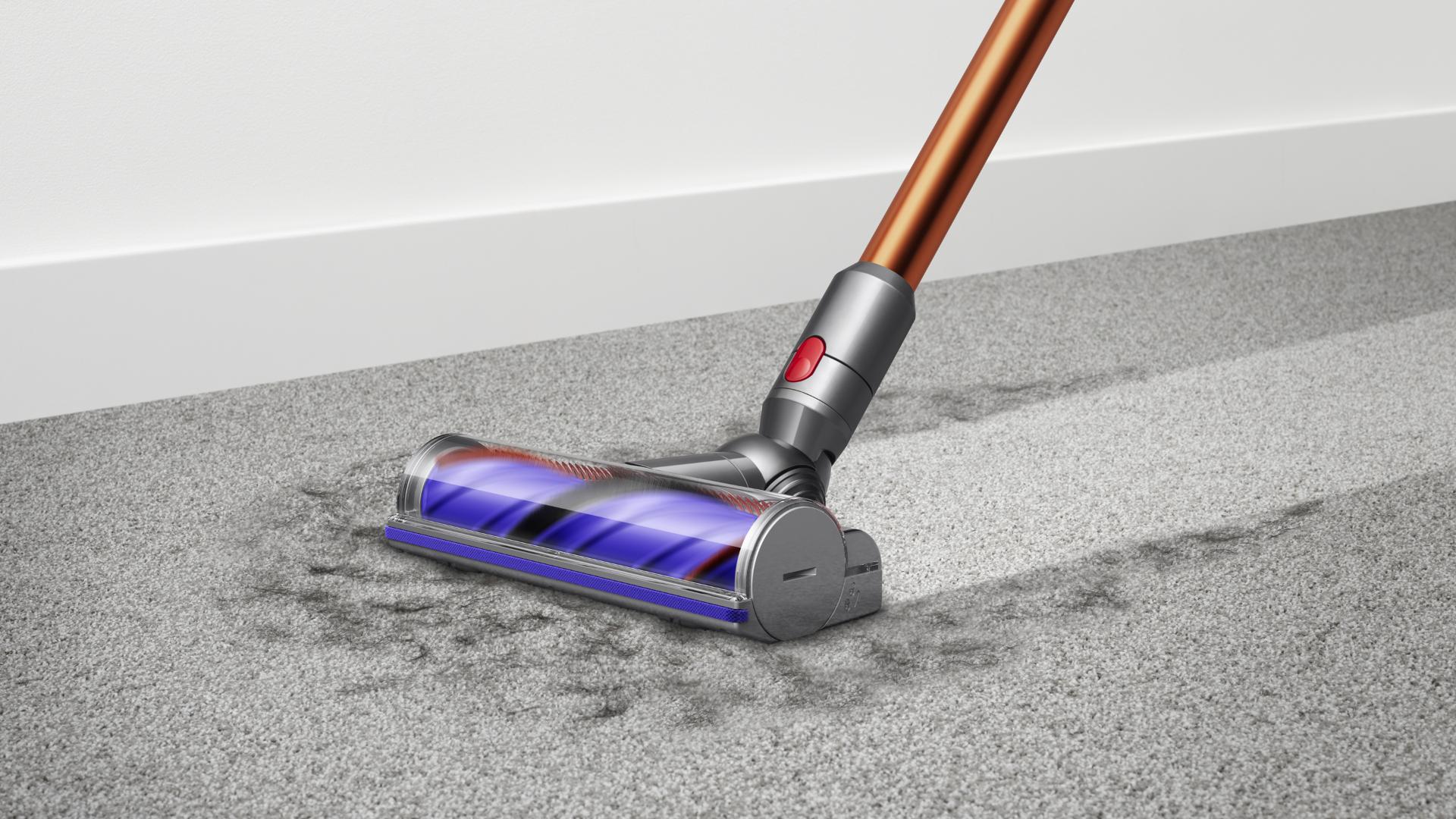 Woman cleaning floor using Dyson cyclone V10 vacuum cleaner 