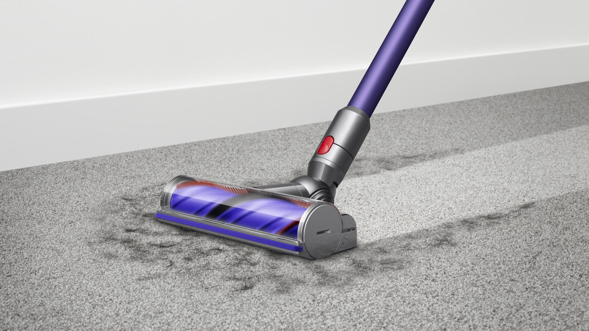 Woman cleaning floor using Dyson cyclone V10 vacuum cleaner 