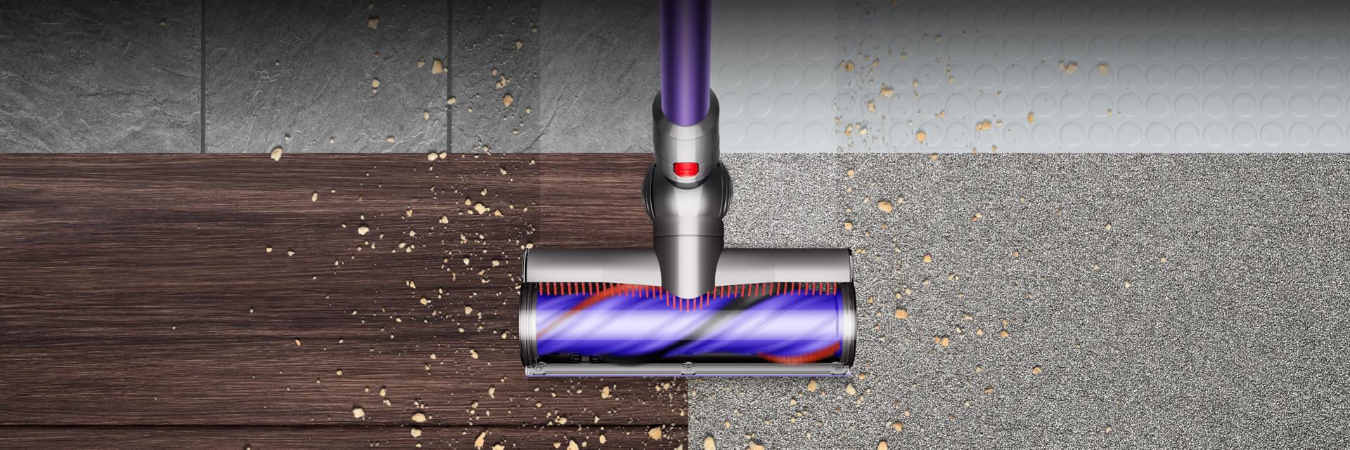 The Dyson Cyclone V10 vacuum cleaner's torque drive cleaner head picking up debris across multiple floor surfaces.