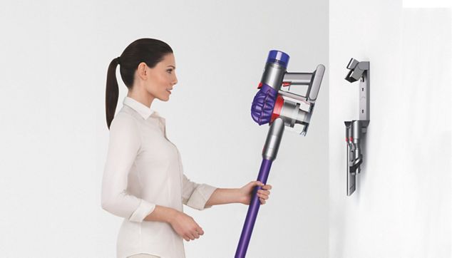 Model with Dyson wall-mounted dock