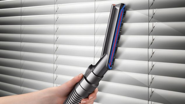 Carbon fibre soft dusting brush being used to vacuum blinds