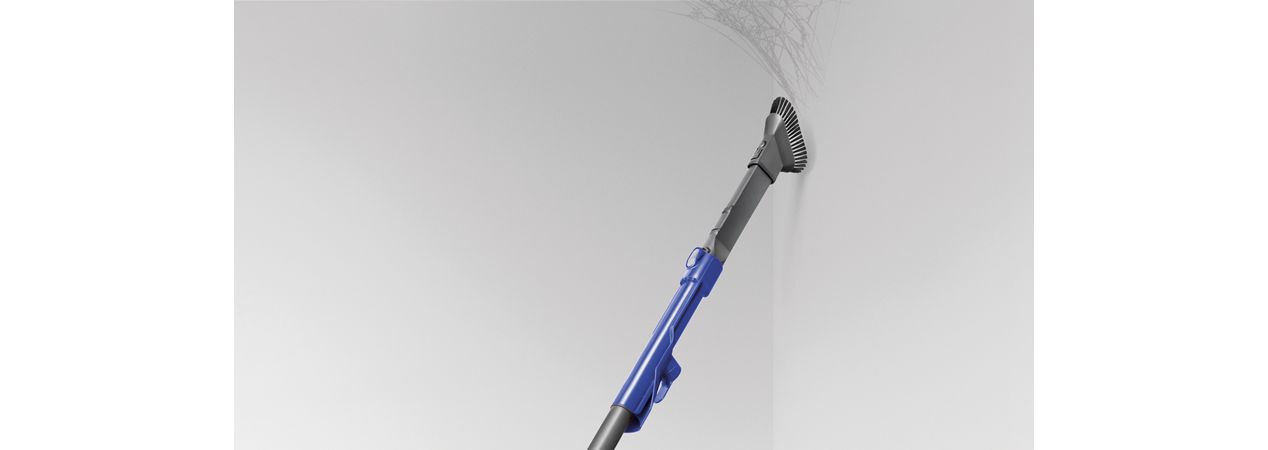 Combination tool being used in corner of ceiling