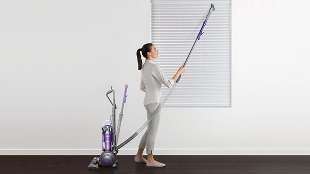Wand being used to clean hard to reach area
