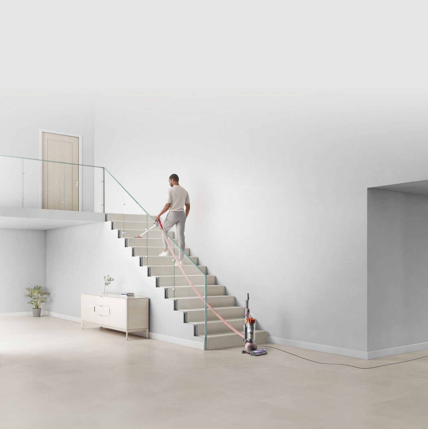 Man cleaning stairs using the extension hose