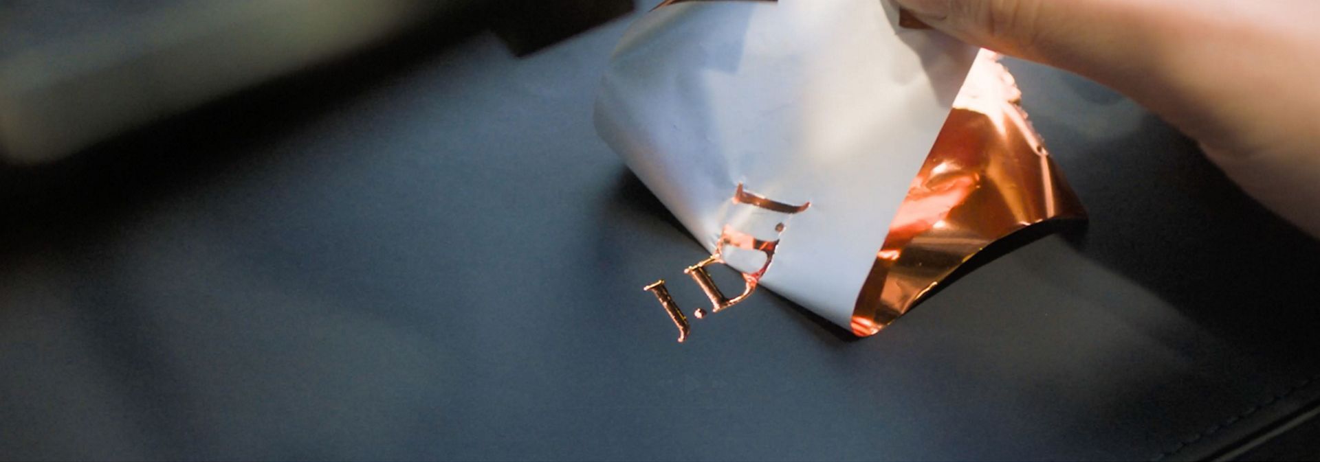 Initials are debossed onto a Dyson Presentation case.