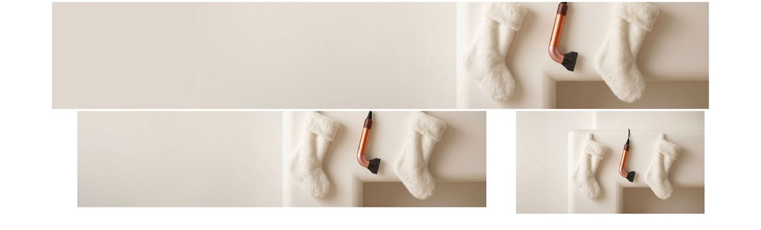 De Dyson Supersonic r haardroger hangt in een rij tussen een paar kerstkousen.