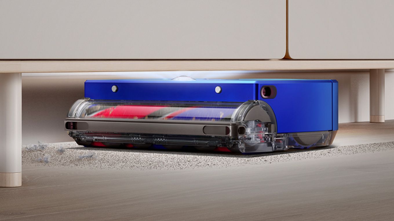 The Dyson 360 Vis Nav robot vacuum cleans under a low cabinet.