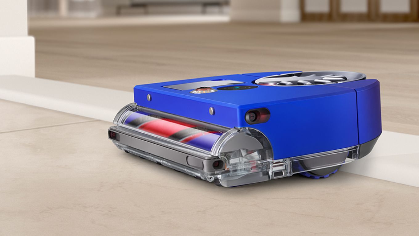 The Dyson 360 Vis Nav robot vacuum moves between rooms.