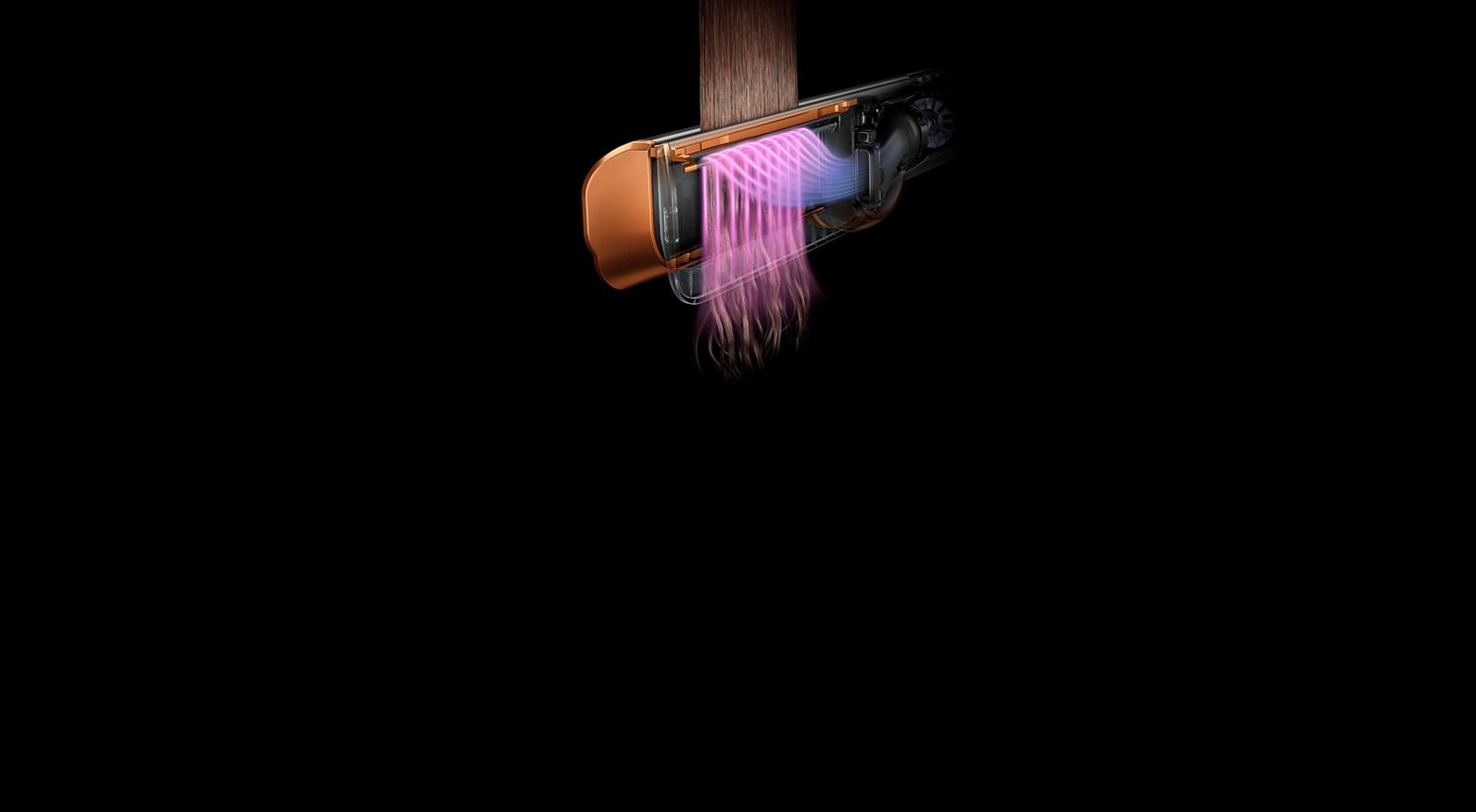 Close-up of the Dyson Airstrait straightener showing warm airflow straightening hair. Close-up of the Dyson Airstrait straightener showing warm airflow straightening hair.