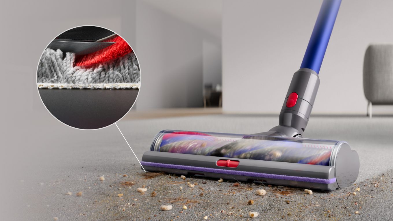 Low-angle close-up of the Digital Motorbar XL cleaner head removing debris from carpet.