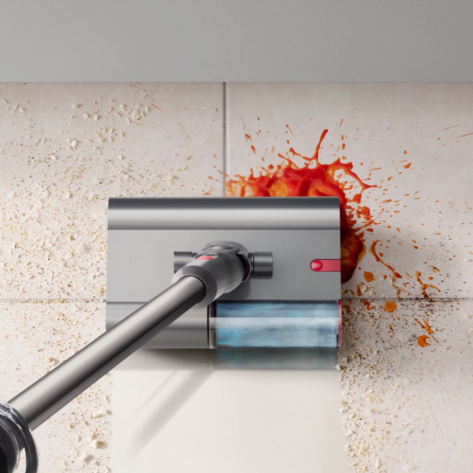 The Dyson V12s Detect Slim Submarine Complete vacuum cleaner cleaning a kitchen floor.