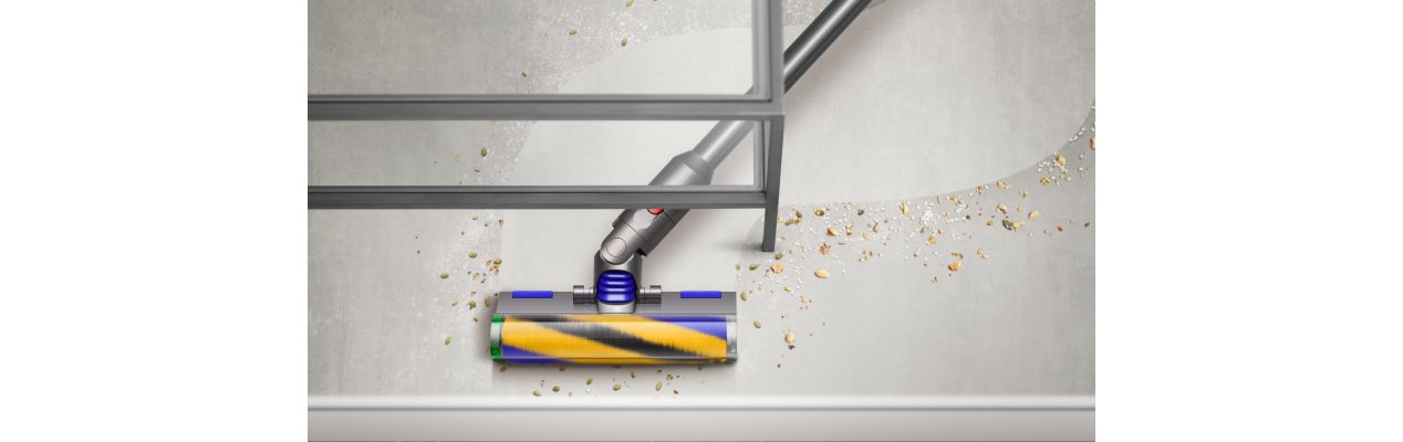 The Dyson V12 Detect Slim vacuum cleaning under a table