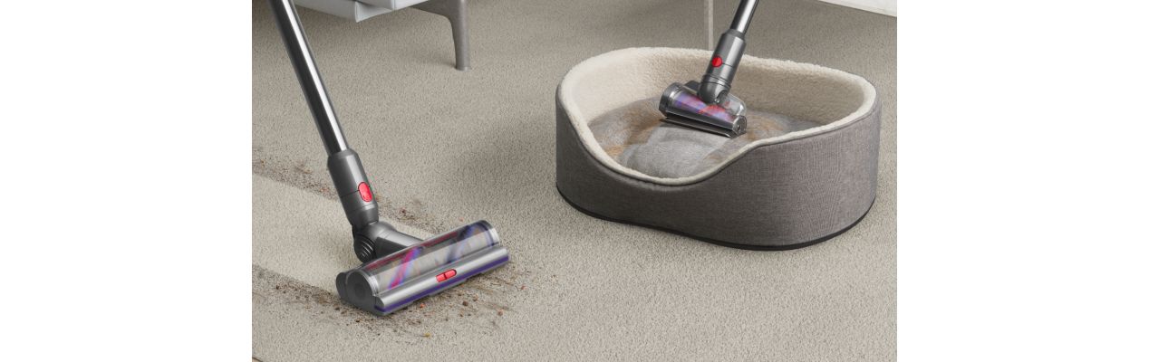 The Dyson V12s Detect Slim Submarine Complete vacuum cleaner cleans a carpet and a pet's bed.