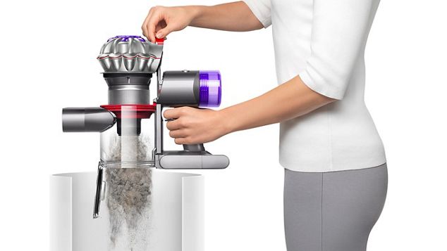 The Dyson V8 vacuum being emptied in a bin.