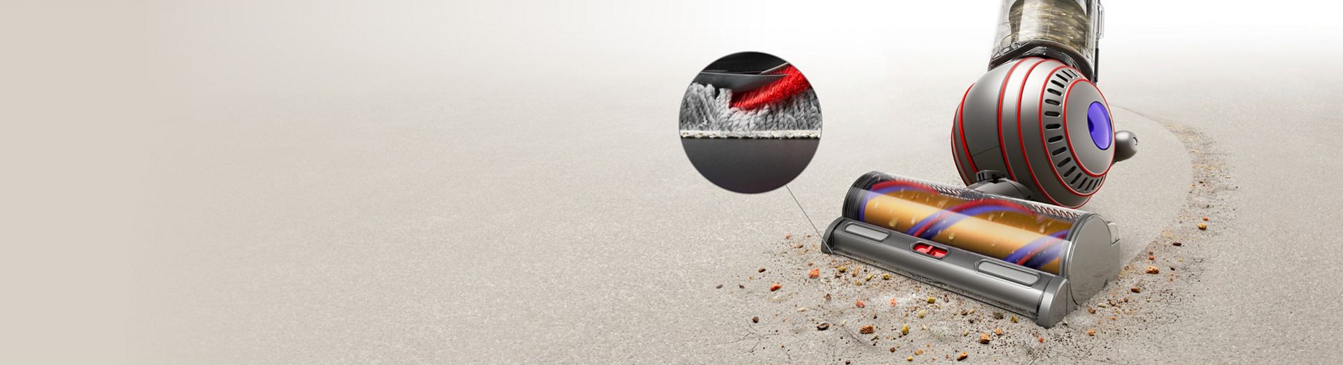 Close-up of the Dyson Ball Animal Complete vacuuming carpet, with detail close-up of carpet fibres.