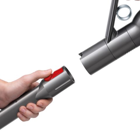 A person removing their vacuum cleaner attachment with a single click.