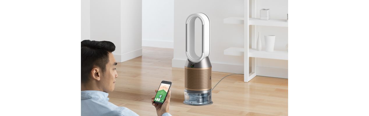 A man controls his Dyson air purifier using his smartphone.