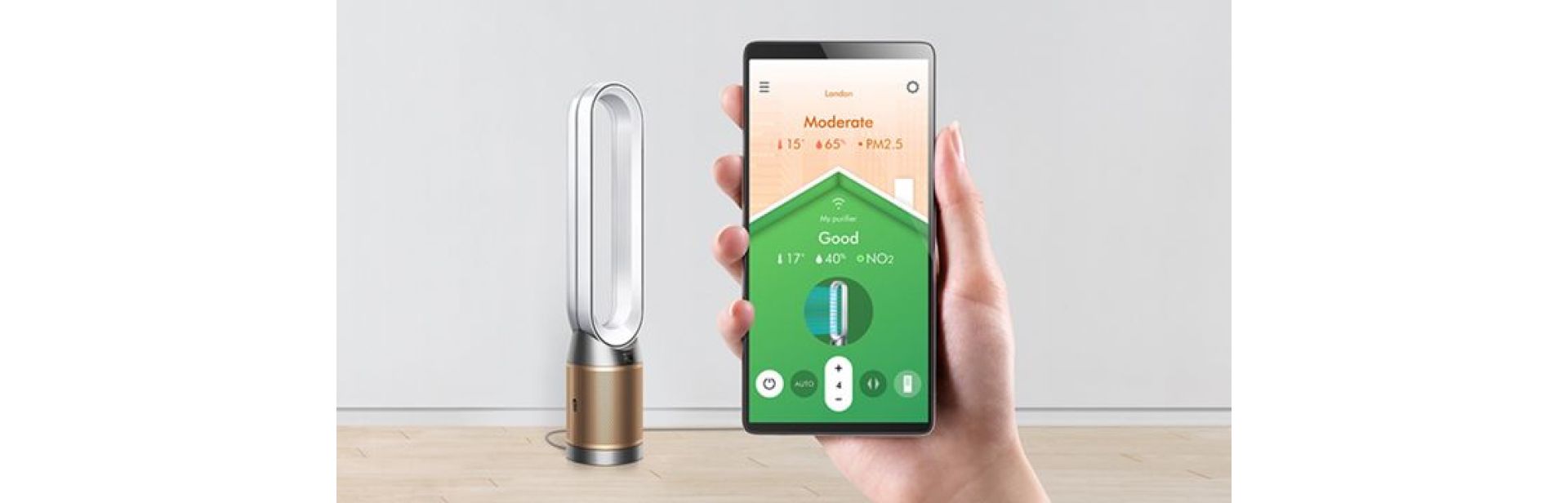 A hand holding a smartphone showing the air quality screen, with the Dyson Purifier Cool Formaldehyde.