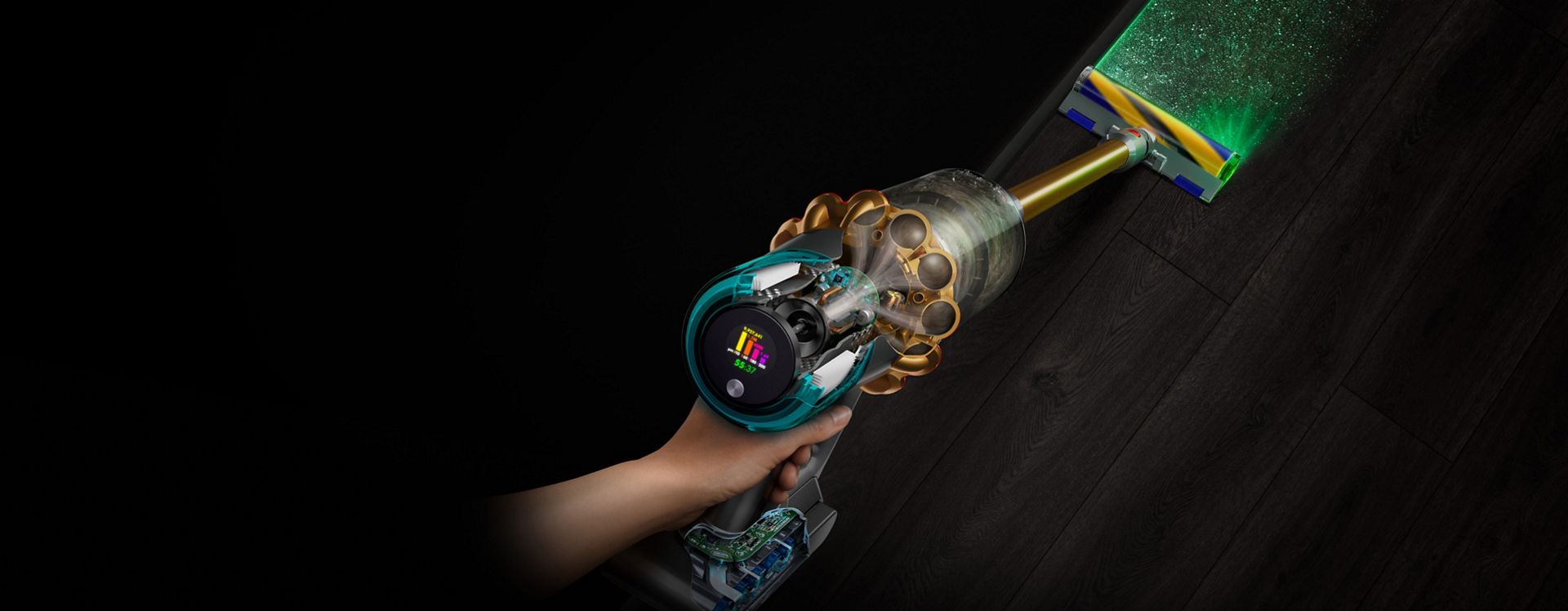 Vista dall’alto dell’aspirapolvere Dyson V15 Detect con la spazzola Fluffy Optic che illumina la polvere nascosta.