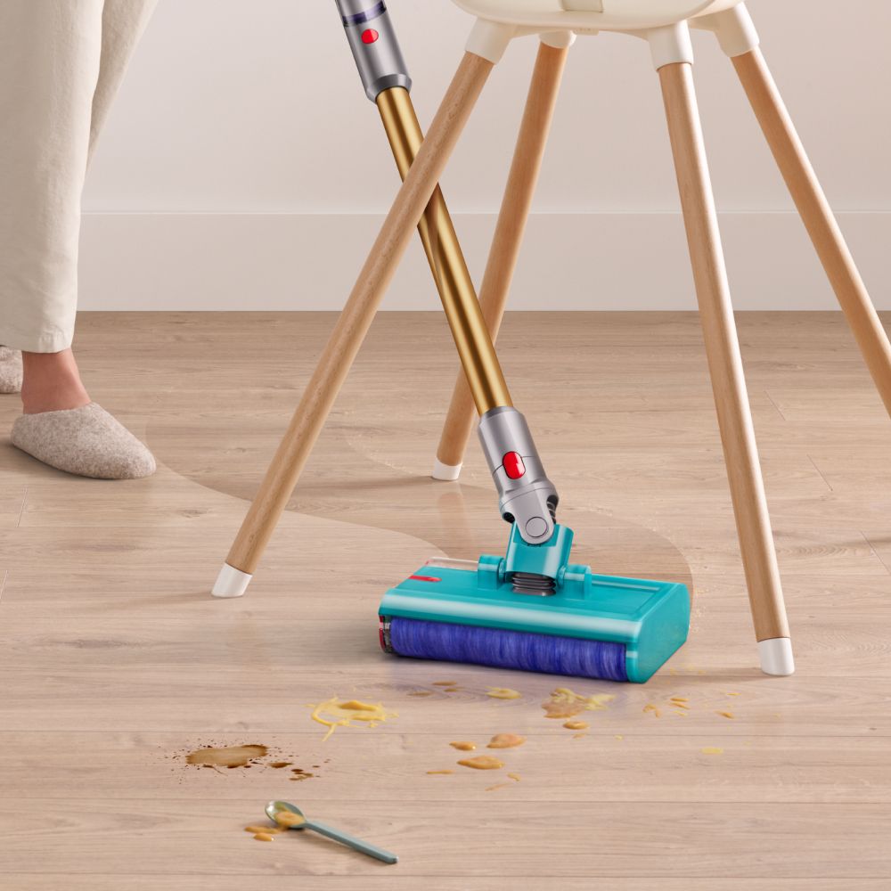 The Dyson V15s Detect Submarine cleans around the legs of a high chair.