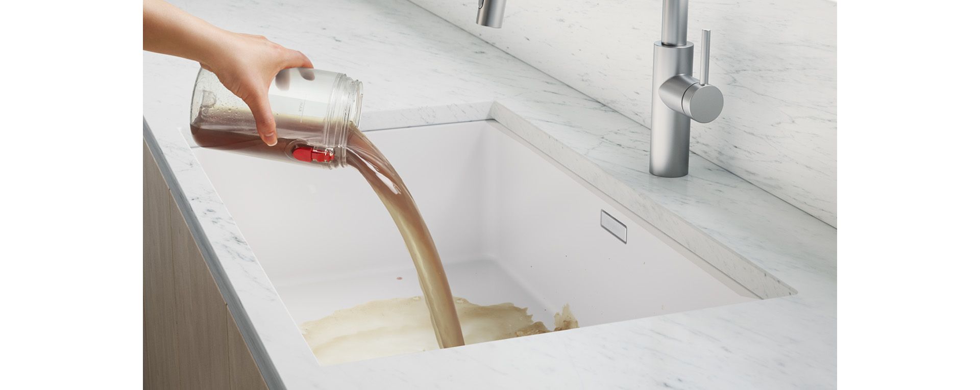 Emptying the dirty water tank into a sink.