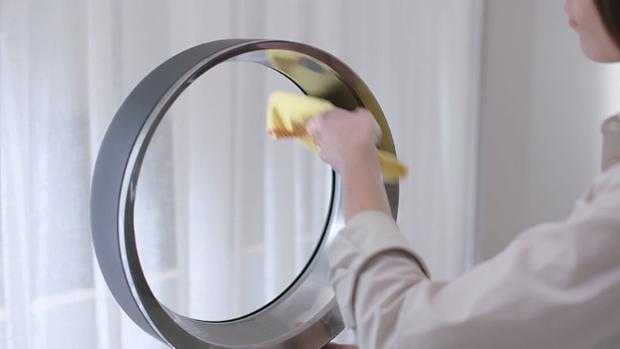 Woman cleaning Dyson fan