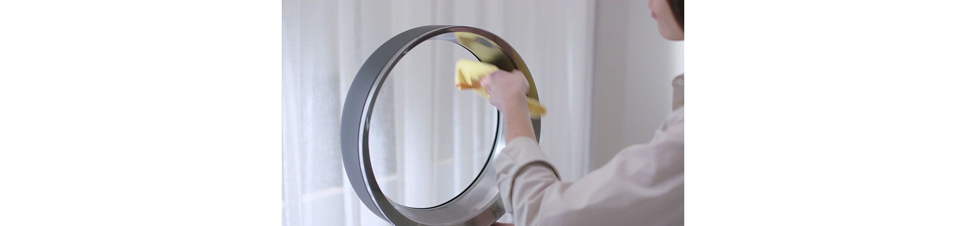 Woman cleaning Dyson fan