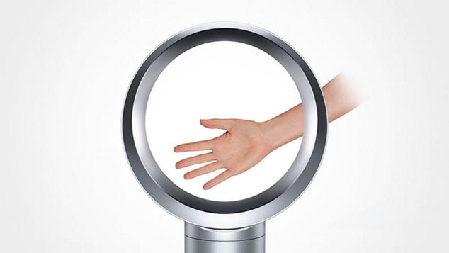 Hand in Dyson fan to demonstrate how safe it is