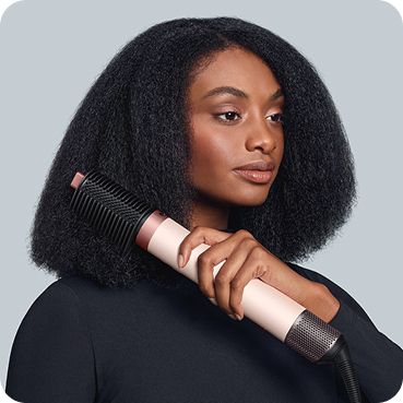 The Dyson Airwrap Co-anda2x multi-styler and dryer lengthening and straightening hair