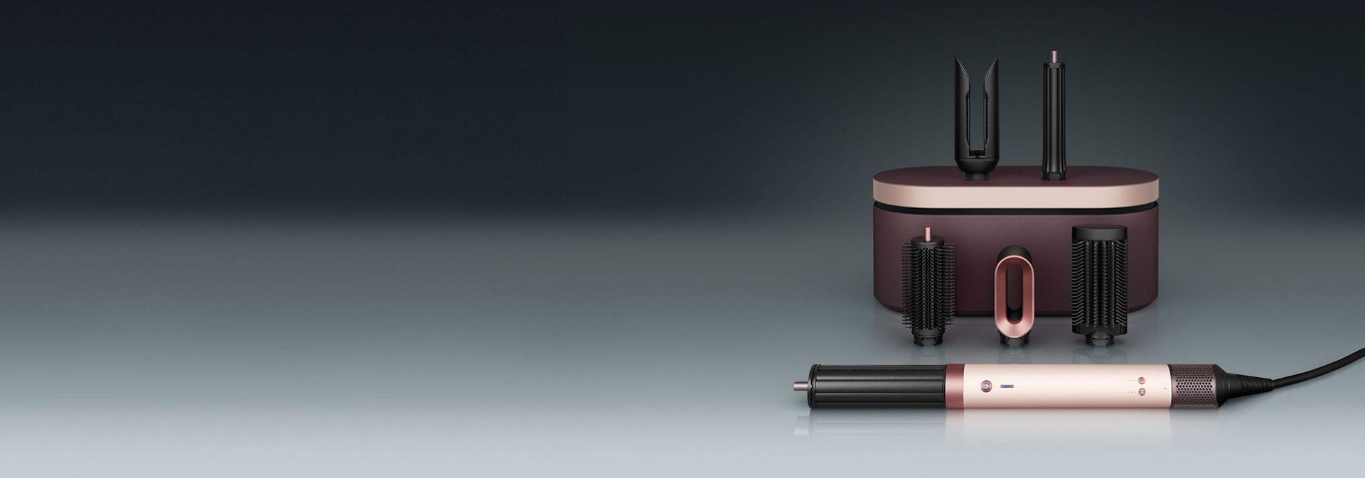 A model diffuses her coily hair using the Dyson Airwrap Co-anda2x multi-styler and dryer.