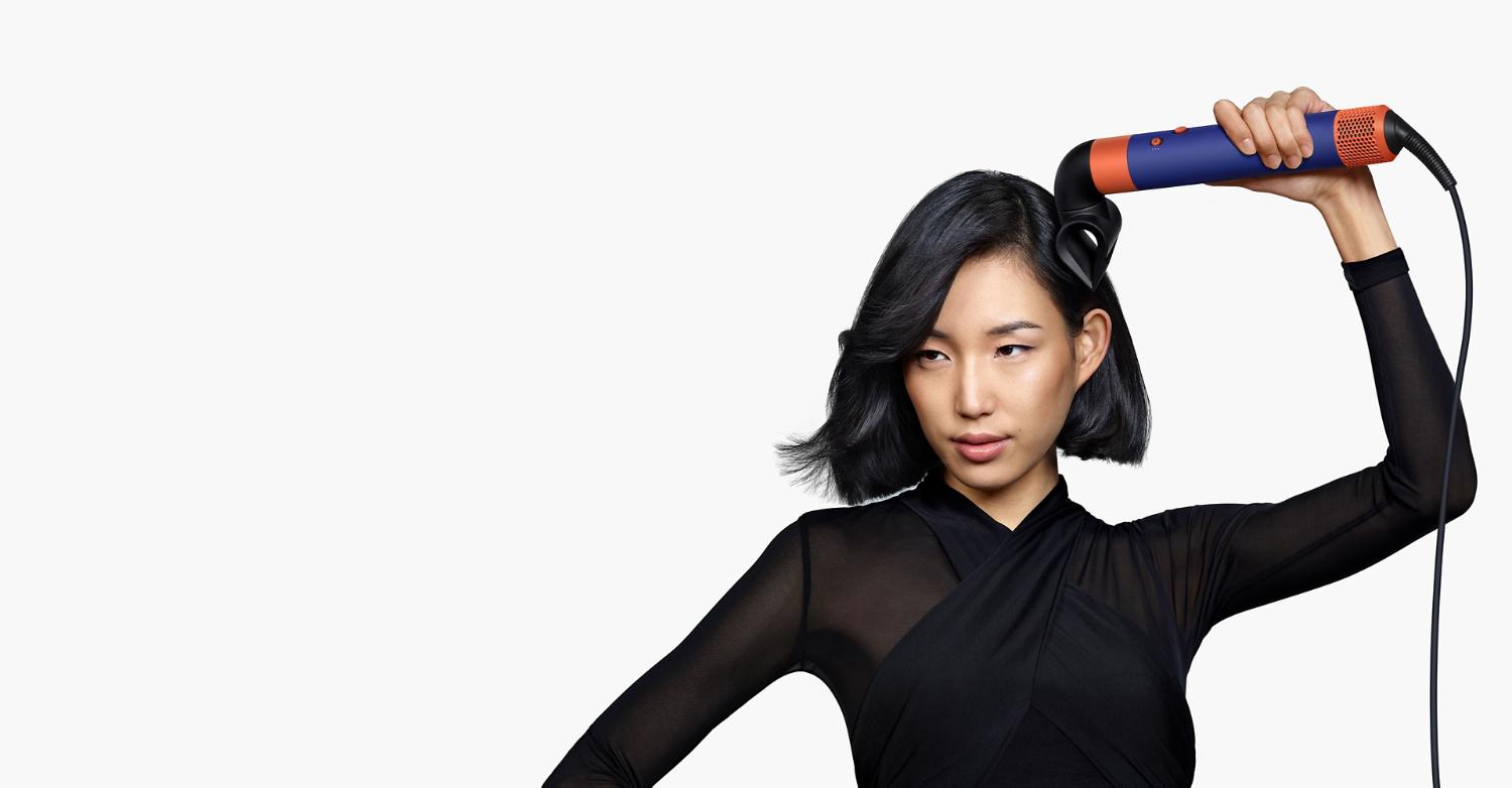A model using the Blade concentrator for the Dyson Airwrap multi-styler and dryer.