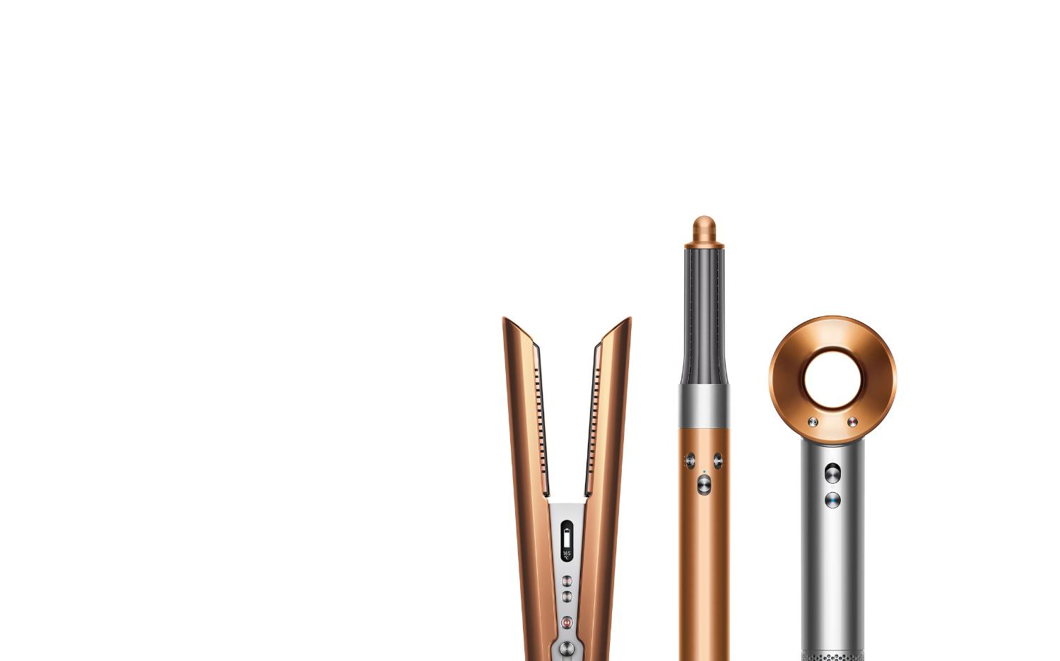A line-up of Dyson hair care machines in copper and nickel.