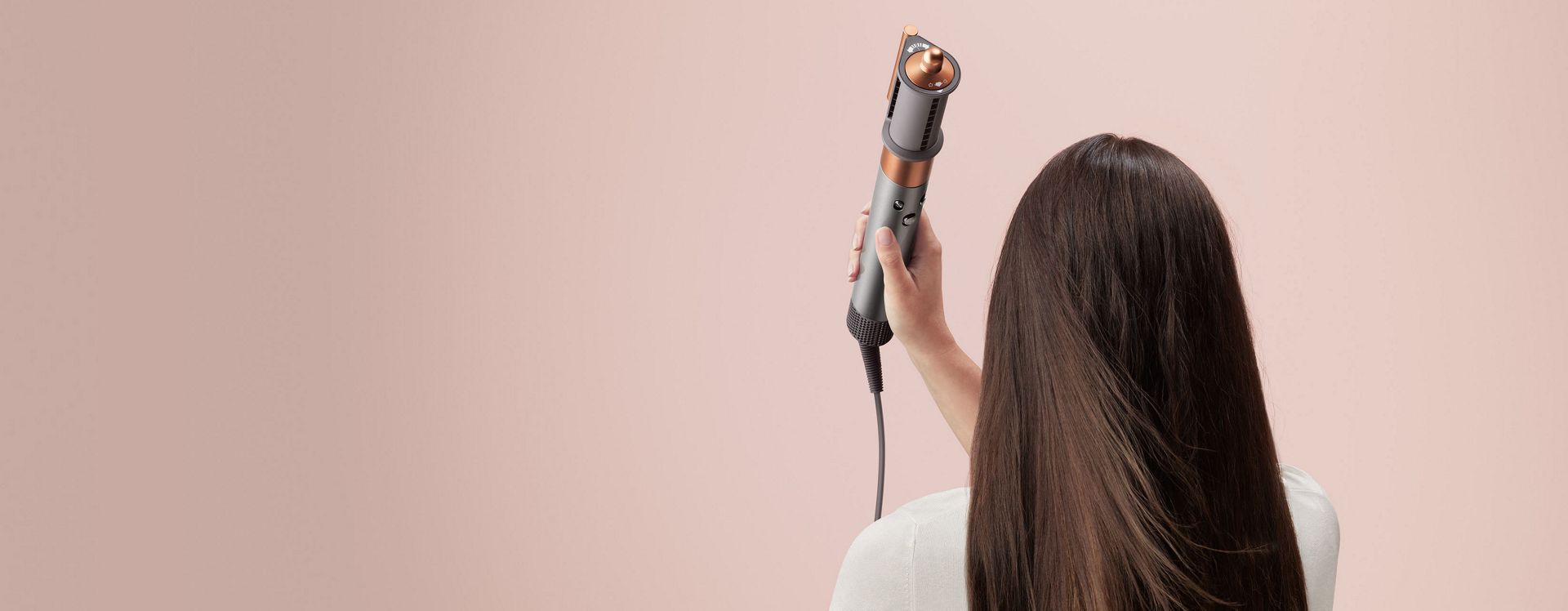 Model using Dyson Airwrap's Coanda smoothing dryer.