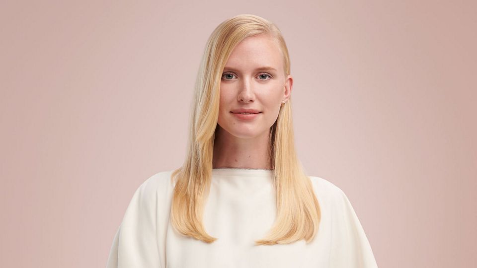 Model wearing a sleek side part style