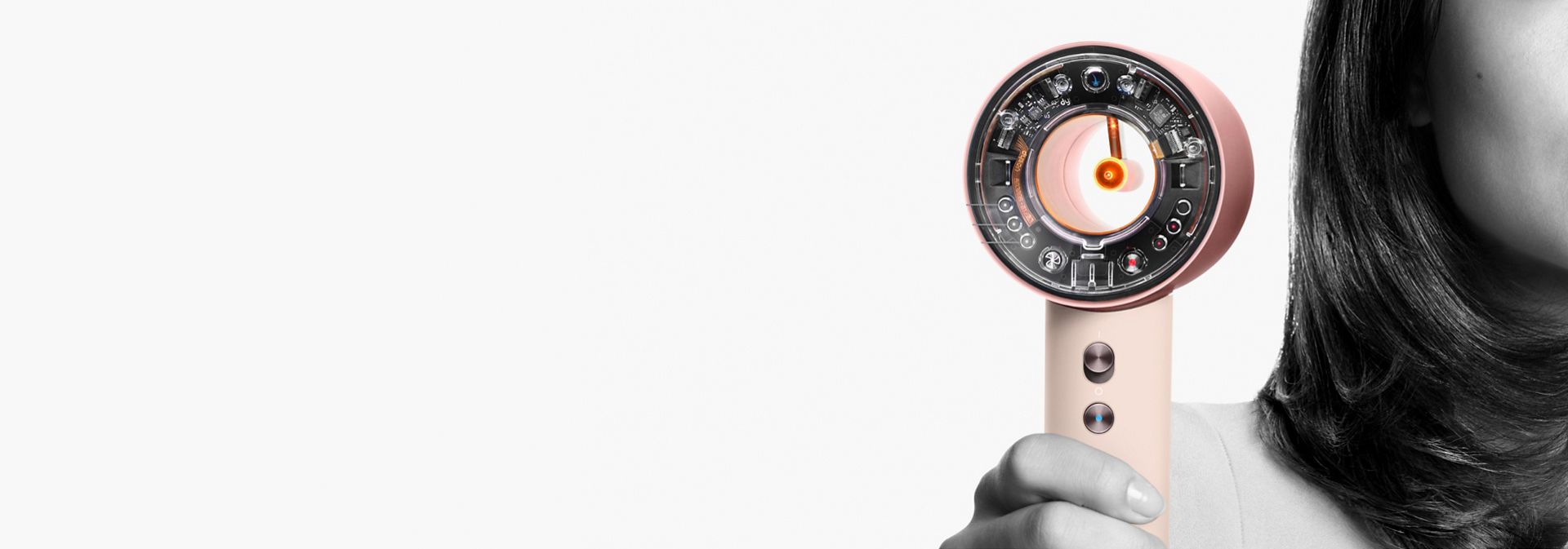 The Dyson Supersonic nural held by a model.