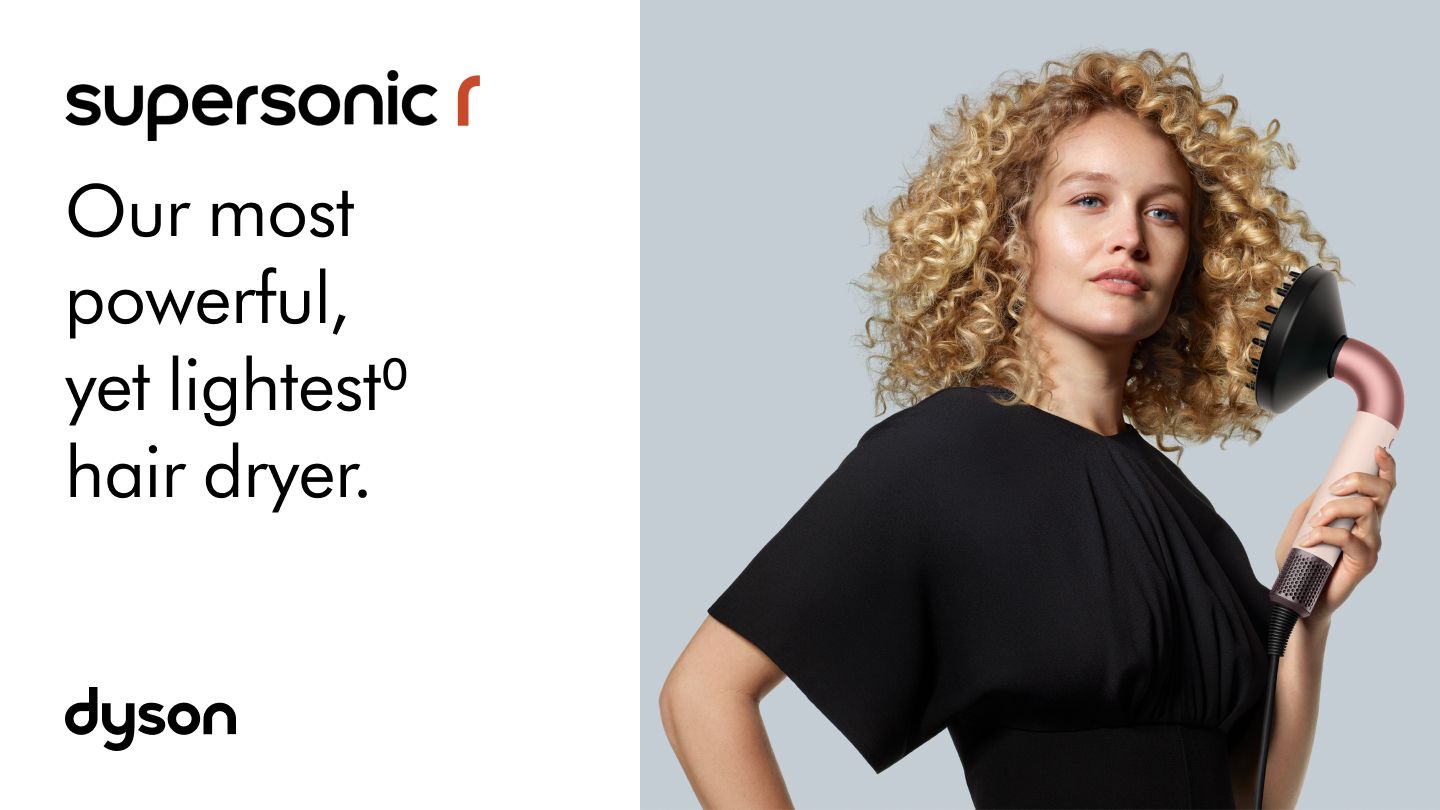 The Dyson Supersonic r is held by a model. Our most powerful, yet lightest⁰ hair dryer.
