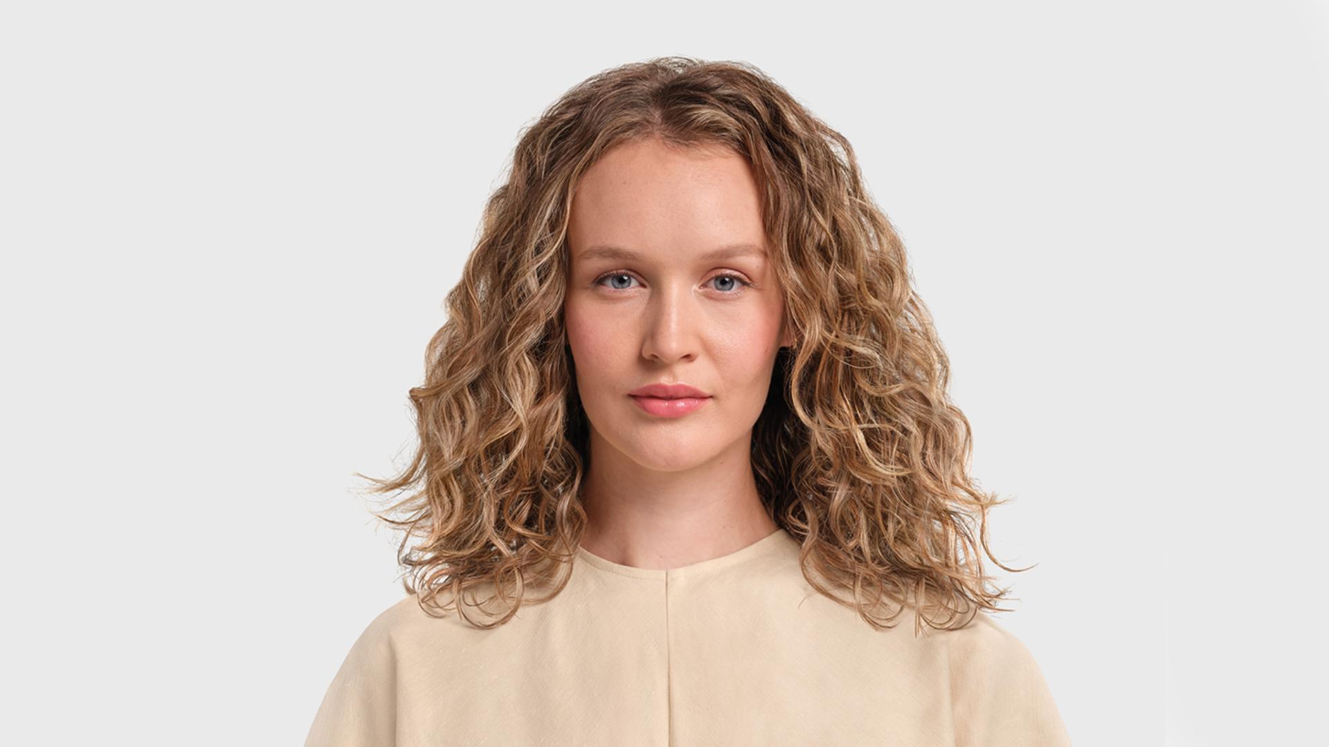 Model with Curtain bangs styled hair.