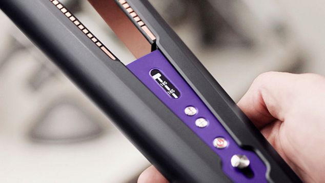 Close up of professional stylist using a cordless Dyson Corrale hair straightener 