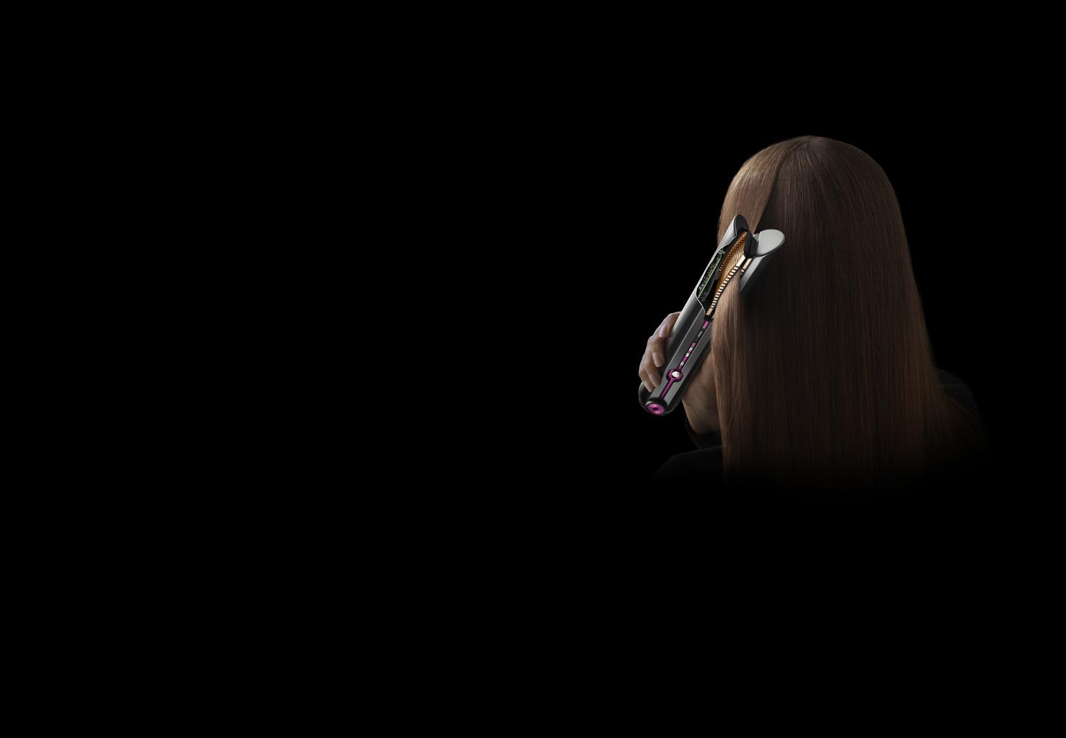 Woman styling hair with a Dyson Corrale straightener